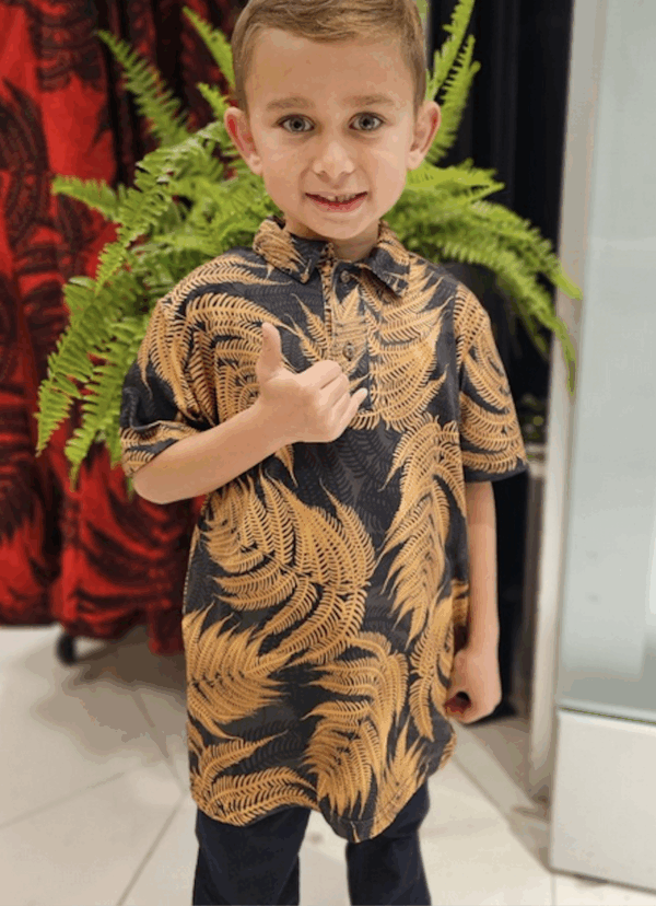 Little boy wearing tan and black shirt